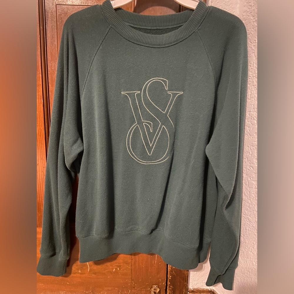A green Victoria’s secret crewneck sweater
